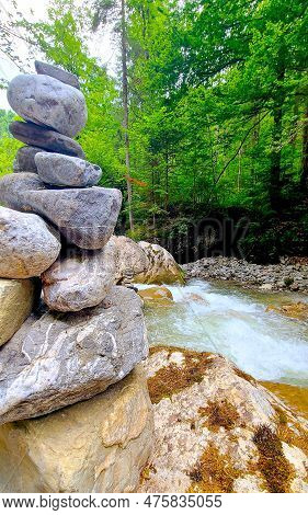 A Pyramid Of Stones Over A River In A Mountain Gorge Against A Background Of Forest, Natural Balance