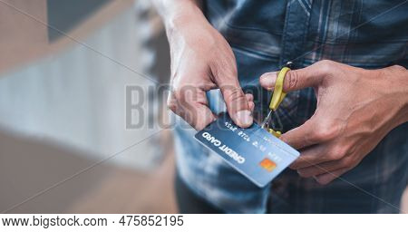 Male Hands Using Scissors To Cut A Credit Card. Concept Of Debt Crisis With Young Man Destroying Cre