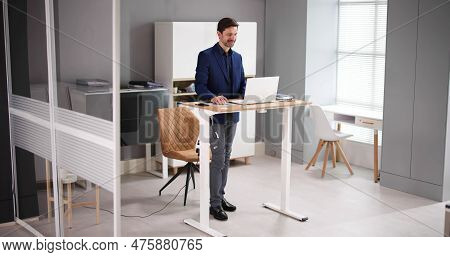 Adjustable Height Desk Stand In Office Using Computer