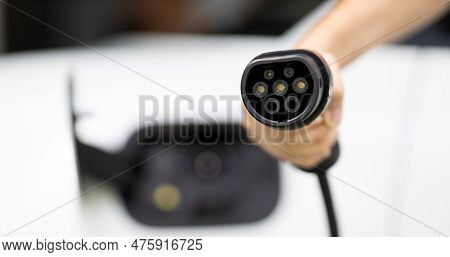 Progressive New Alternative Clean Energy Vehicle And Electric Charging Device Concept. Focus Closeup