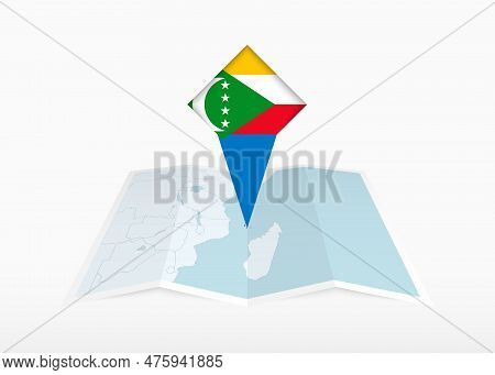 Comoros Is Depicted On A Folded Paper Map And Pinned Location Marker With Flag Of Comoros. Folded Ve