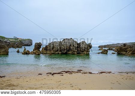 View On Playa De Toro In Llanes, Green Coast Of Asturias, North Spain With Sandy Beaches, Cliffs, Hi
