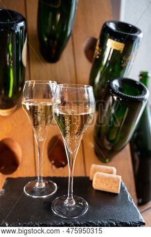 Glasses Of Sparkling White Wine Champagne Or Cava With Bubbles And Classic Wooden Champagne Pupitre
