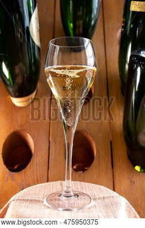 Glasses Of Sparkling White Wine Champagne Or Cava With Bubbles And Classic Wooden Champagne Pupitre