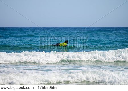 Young Surfers Train On Playa De Palombina Las Camaras In Celorio, Green Coast Of Asturias, North Spa