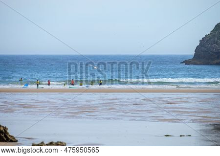 Young Surfers Train On Playa De Palombina Las Camaras In Celorio, Green Coast Of Asturias, North Spa