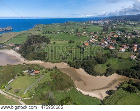 Aerial View On Playa De Poo During Low Tide Near Llanes, Green Coast Of Asturias, North Spain With S