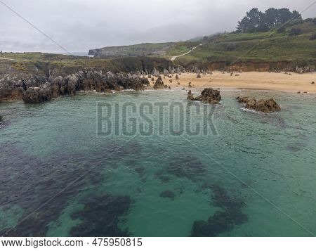 Aerial View On Playa De Toro In Llanes, Green Coast Of Asturias, North Spain With Sandy Beaches, Cli