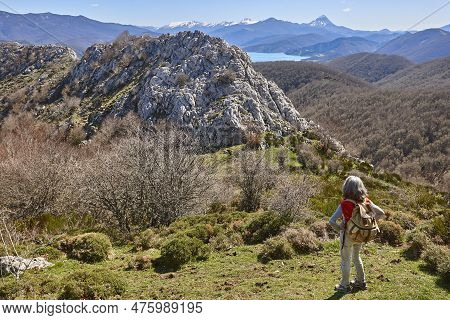 Picturesque Reservoir And Mountain Landscape In Riano. Hikers. Spain
