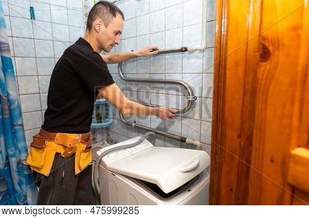 Repair Of Household Appliances At Home With Their Own Hands. The Repairman Repairs The Washing Machi