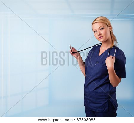 Pretty young nurse in hospital listening to empty copy space with sthetoscope