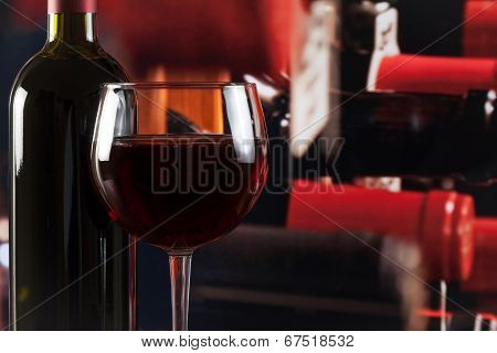 Wine Glass Near Bottle In Wine Cellar With Space For Text