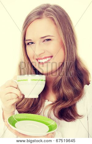 Young attractive corpulent blond woman drinking coffee