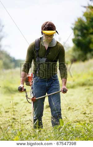 Man Working With Grass Trimmer