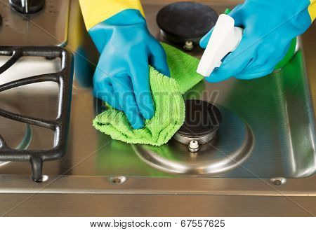 Gloved Hands Cleaning Stove Top Range With Spray Bottle And Microfiber Rag