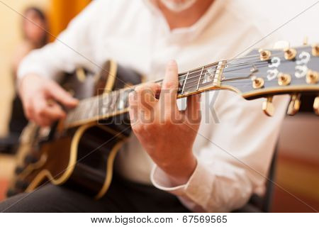 Guitarist playing an archtop guitar