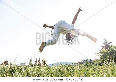 Capoeira woman awesome stunts in the outdoors
