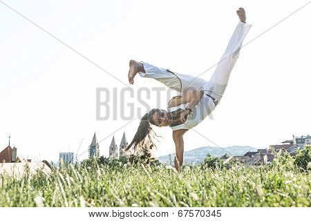 Capoeira woman awesome stunts in the outdoors