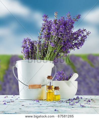 Harvested lavender flowers on wooden planks, blur field on background