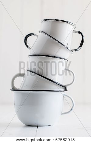 Five White Enameled Mugs