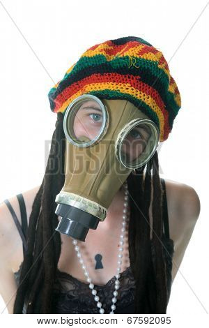 a girl in a gas mask wears her favorite Rastafarian style hat with built in Dred locks. isolated on white with room for your text.