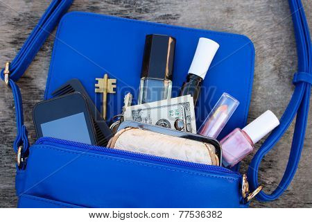 Blue women's purse. Things from open lady hand bag.