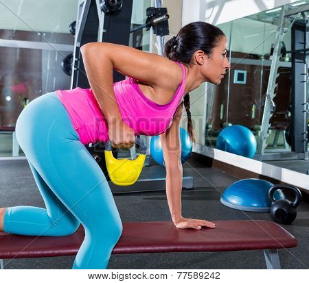 girl one arm kettlebell bent over row on bench workout exercise at gym