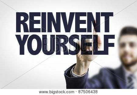 Business man pointing the text: Reinvent Yourself