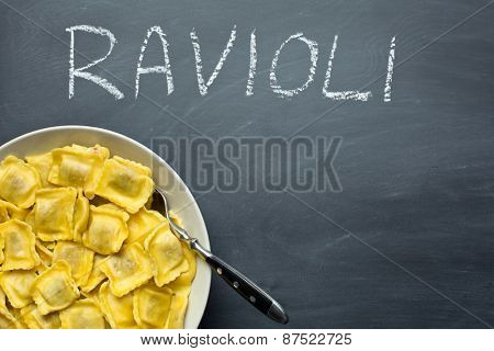 cooked ravioli pasta on chalkboard