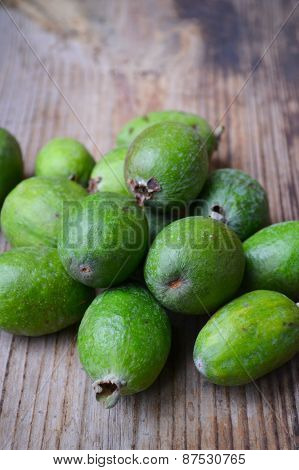 Green feijoa fruit on wooden table