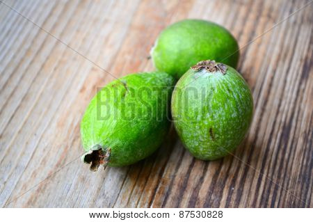 Green feijoa fruit on wooden table