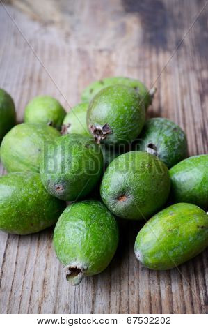 Green feijoa fruit on wooden table