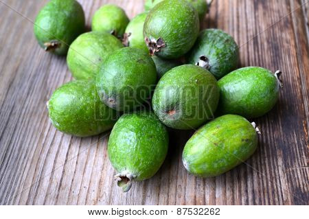 Green feijoa fruit on wooden table
