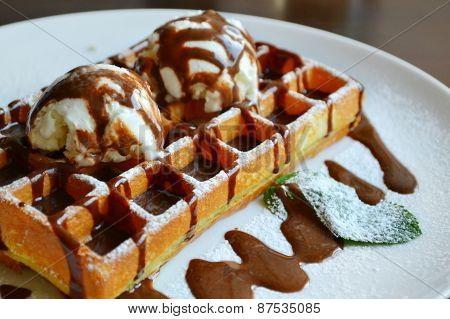 Belgian waffle with ice cream, chocolate and mint