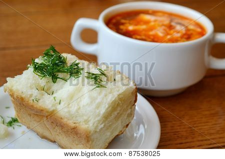 National Ukrainian soup borsch with traditional bread pampushki with garlic