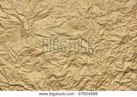 Close-up Of Rough Golden Brown Wrinkled Packaging Paper Texture Background