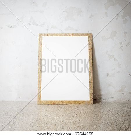 Blank white wooden natural frame on a cocrete wall