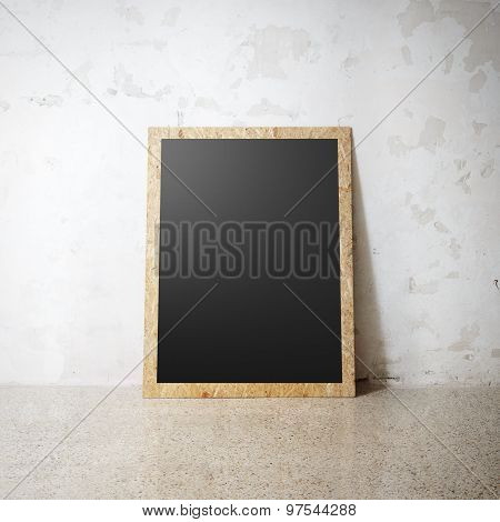 Blank black wooden natural frame on a cocrete wall