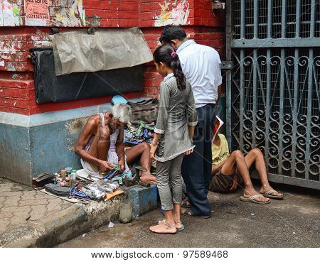 Shoe Shiner Does His Job At Street Of Kolkata