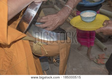 people give alms to a Buddhist monk on morning