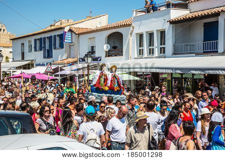 Saintes-Maries-de-la-Mer, France - May 25, 2015. Religious feast in honor of the Holy Maries in Provence. The concept of ethnographic tourism. The crowd is accompanied by two statues Holy Maries