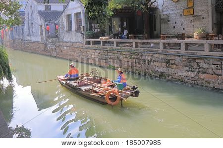 SUZHOU CHINA - NOVEMBER 3, 2016: Unidentified people clean canal in Pingjiang historical district. Pingjiang historical street was a major thoroughfare of eastern Suzhou in Southern Song Dynasty.