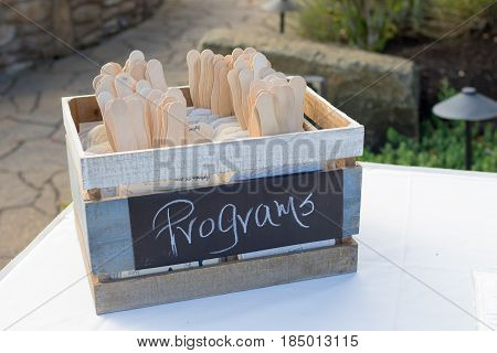 Chalkboard sign for programs at a golf course wedding ceremony in Oregon.