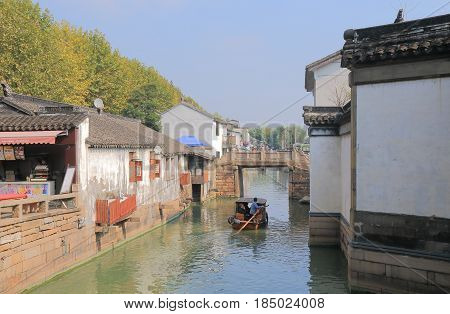 SUZHOU CHINA - NOVEMBER 3, 2016: Unidentified people take a cruise boat in historical district of Suzhou.