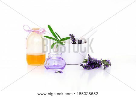 lavender flowers lavander extract oil and montar with dry flowers isolated on white.