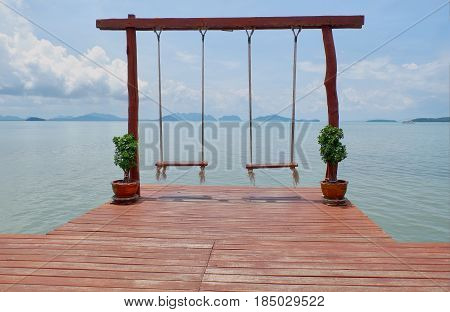 wooden swing and wood floor near the sea on Phi Phi Island Thailand