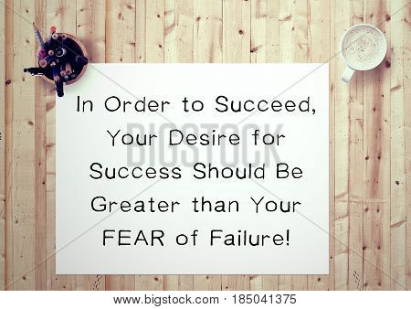 Inspiring motivation quote handwritten on a notepad in order to succeed, your desire for success should be greater than your fear of failure. White pad paper image.