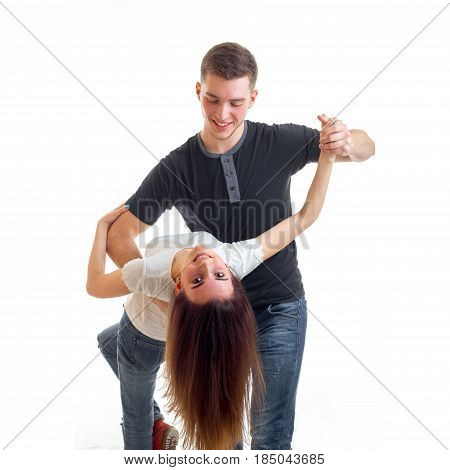 young handsome guy tilted the girl with long hair down dancing isolated on white background