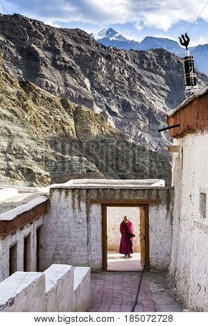 Rizong, India - August 17, 2015: A Buddisth monk wait for visitors at the entrance of Rizong Monastery. It is situated at the top of a rocky side valley on the north side of the Indus river