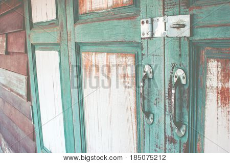 Green asian ancient wooden slide door with handle and keylock. The ancient door for back to the past.